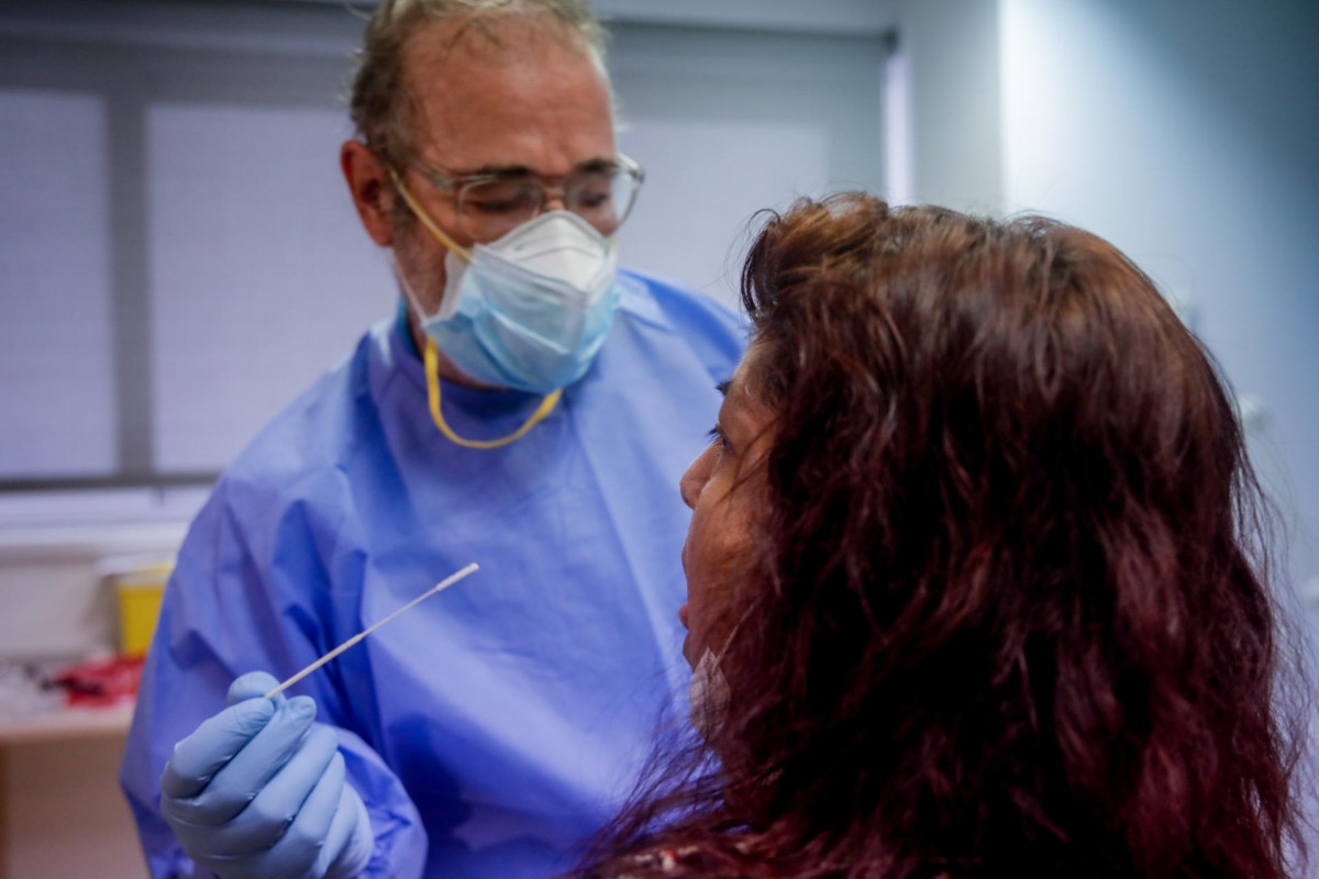 Un trabajador sanitario realiza una prueba PCR a una de las personas que ha acudido durante la jornada de hoy a realizarse un test al dispositivo instalado en el Centro de Especialidades El Arroyo, en