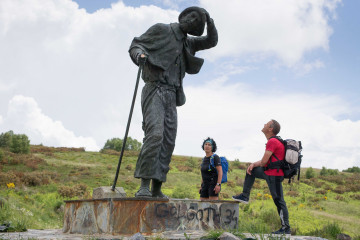 Archivo - Dos peregrinos bilbaínos observan la estatua al peregrino en el Alto do San Roque por donde transcurre el Camino de Santiago francés, a 16 de junio de 2021, en Lugo, Galicia (España). Des