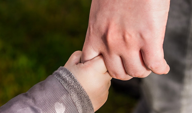 Archivo - Imagen de recurso de un niño de la mano de un adulto